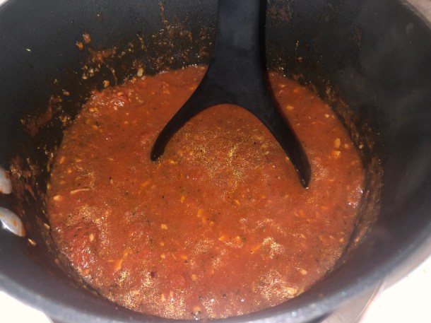 Cooking Eorzea | Mashing San Marzano tomatoes into pizza sauce.