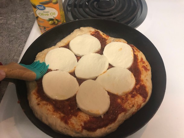 Cooking Eorzea | Adding mozzarella and then brushing the crust with olive oil.